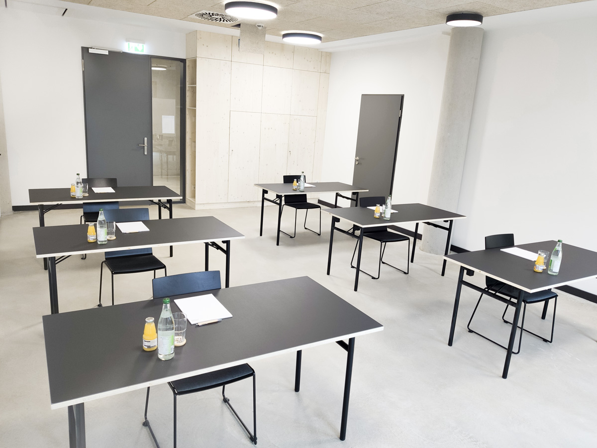 Seminarraum 3 Arbeitsraum mit weißen Wänden und schwarzen Tischen und Stühlen